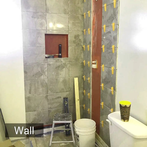 Tile Leveling System With Plier And 300 Clip Spacers And 100 Reusable Wedges For Stone And Tile Installations on bathroom wall.