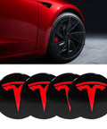 4 Pack Aluminum Waterproof Wheel Cover Center Emblem Sticker For Tesla Model 3 And Model Y 56mm Hubcaps 4 Pieces With Black Background Red Emblem Fits 18 Inch Model 3 And 19 Inch Model Y Wheels on display with Tesla car