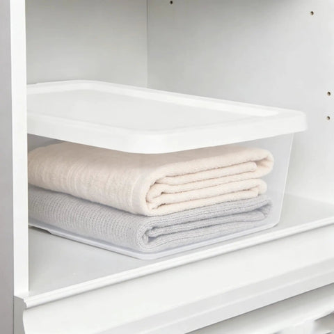 Heavy Duty Clear Plastic Storage Bins With Secure Snap On Lids Super Solid Twelve Quart Capacity Sweet Four Pack holding towels in a cabinet.