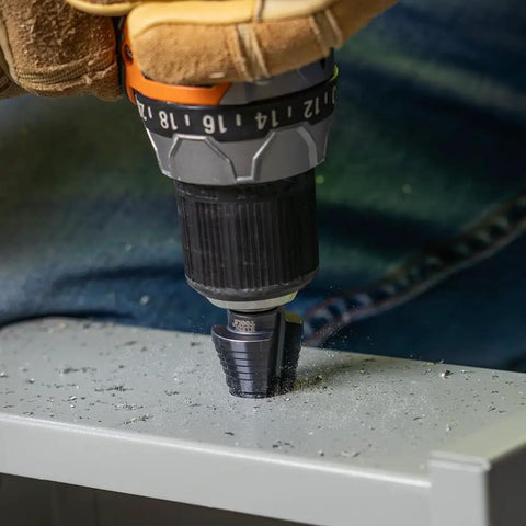 Drilling metal with Step Drill Bit With Aluminum Titanium Nitride Coating For Long Lasting Durability, double fluted design visible.