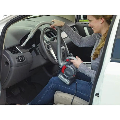 Person using Compact 12V Flexi Automotive Vacuum With 4 Ft Hose Crevice Tool 2in1 Wide Nozzle And Flip Up Brush Corded Handheld Car Vacuum For Tight Spaces And Quick Cleanups Built For On The Go Cleaning Motor In The Filter Tech in car interior