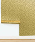 Glow Up Your Space With Top Shelf Abstract Scalloped Gold Metallic Wallpaper For Modern Interiors Eco Friendly PVC Free Wallcoverings Made In America Paste The Wall Ready, showcasing a rolled edge detail.