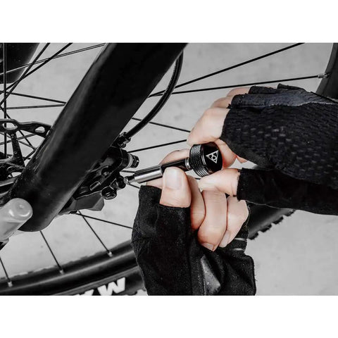 Using Torq Stick Pro 4-20 Nm Torque Wrench Kit with Mini Ratchet on bicycle wheel for precise tightening.