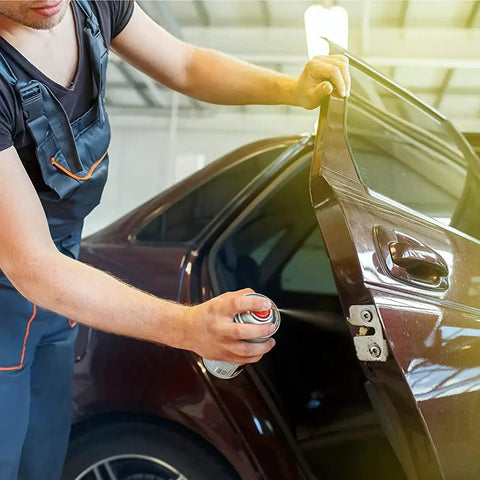 Mechanic using Go-To Dual Force Multi-Purpose Lubricant And Penetrant Aerosol on car door hinge, 14 oz can, low odor formula.