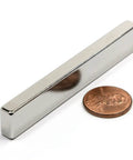 Neodymium Bar Magnet N45 3 By One Half By One Quarter Inch With 3M Foam Adhesive Seriously Strong beside a penny for scale