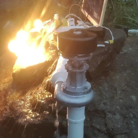 Compact 500W Micro Hydroelectric Generator With Copper Core Coil installed by a creek with water flowing, 220V