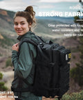 Woman hiking outdoors wearing a Tactical Backpack For Work And Outdoors, 40L Heavy Duty Rucksack With MOLLE, black color.