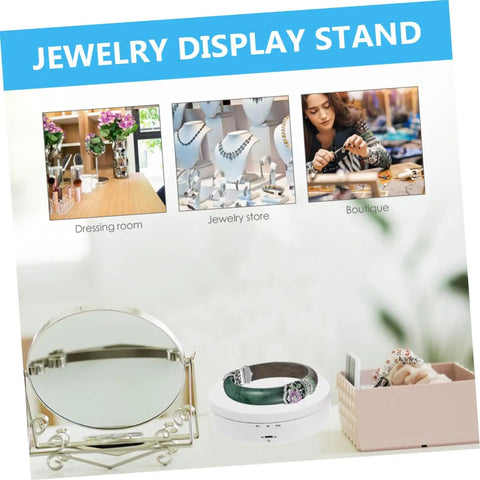 White Electric Rotating Display Stand For Jewelry Watches And Cosmetics Automatic Turntable Showcase with jewelry and mirror in boutique setting.