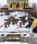 Worker in winter gear outdoors adjusting chains on machinery, highlighting durable use for Winter Work Gloves With Waterproof Barrier And 100g PrimaLoft Gold Insulation Touchscreen Compatible Black And Gray X Large Built For Moderate Cold Weather Grip Ready Durable All Day Comfort For Tough Job Sites.