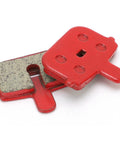 Red brake pads from Eight Pack SemiMetallic Disc Brake Pads for Mountain And Electric Bikes, high heat resistant, angled view.