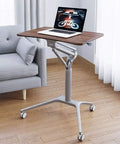 Game Changer Height Adjustable Standing Desk With Silky Gas Lift And Ultra Quiet Lockable Rubber Wheels in home setting with laptop.