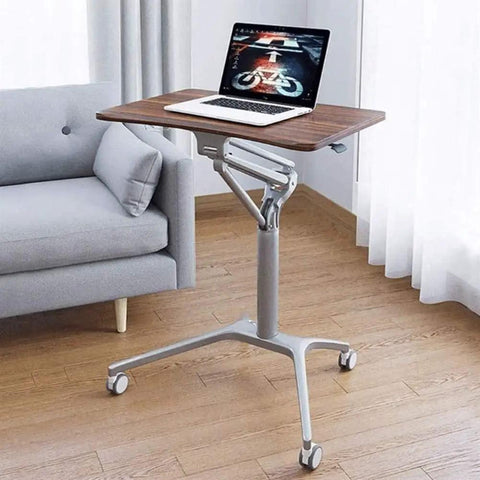 Game Changer Height Adjustable Standing Desk With Silky Gas Lift And Ultra Quiet Lockable Rubber Wheels in home setting with laptop.