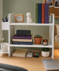 White Desktop Shelf Organizer With Adjustable Two Tier Design Space Saving For Dorm Room And Office holding books and decor.