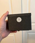 Person holding black 70x148 mm Assay Card Bin for Gold and Silver Storage, Modular Stackable Organizer for Precious Metals Cards.