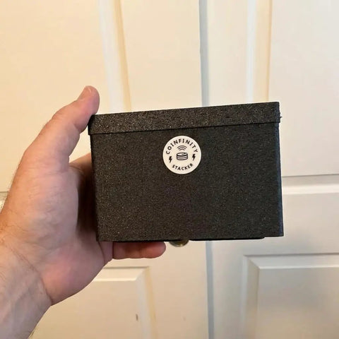 Person holding black 70x148 mm Assay Card Bin for Gold and Silver Storage, Modular Stackable Organizer for Precious Metals Cards.