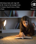 Girl reading under warm light, showcasing Vintage Edison Bulbs 60W Amber Warm Dimmable Incandescent E26 Base For Wall Sconce.