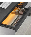Rock Solid Electric Sit Stand Desk With Dual Built In Drawers and Effortless Height Adjustment Featuring Slick Modern Finish Premium Office Writing Table showcasing open drawer with laptop, headphones, and camera.