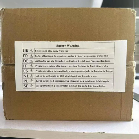 Safety warning label on a cardboard box with multilingual fire safety instructions for the Top Tier 3D Printer Filament Dryer Box.