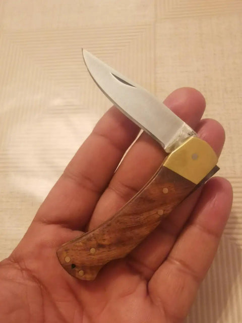 Hand holding Handmade Folding Pocket Knife With Rosewood Handle And Brass Bolsters, Lockback EDC For Camping, 2.2 Inch Blade