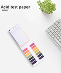 Complete 160 Strip PH Test Paper Kit 1 To 14 Range For Water Soil And Cosmetics with color-coded chart on desk