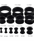Set of black silicone ear tunnels from 8G to 1 inch, part of the 26 Piece Silicone Ear Tunnels Set 8G To 1 Inch Hollow Flexible Soft Ear Stretching Kit For Sleeping, Sports, And Daily Wear Thick Black With Easy On Off Comfort And Secure Fit.