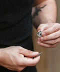 Man holding a V groove pulley and a small tool, showcasing the 20 Pack V Groove Pulleys For Gate Tracks With Deep Groove Ball Bearings Heavy Duty Wear Resistant Roller Bearings Smooth And Easy Slide Built Tough For Long Life V624zz.
