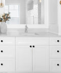 Matte black cabinet knobs on white bathroom cabinet, showcasing the 10 Pack 1-1/5 Inch (30mm) Cabinet Knobs Matte Black.
