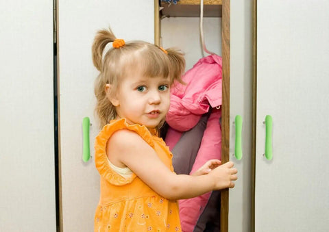 Super Cute Soft Rubber Cabinet Handles 5 Inch Long with Zinc Alloy Base Kid Safe Toddler Friendly Drawer Knobs Rust Proof Smooth Finish Yellow Four Pack Includes Installation Screws on cabinet with child.