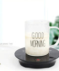 Kickass Smart Touch Cup Warmer Plate 15W Constant Temperature Heating Coaster holding a mug with milk on a black base.