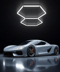 Hexagon LED Garage Light 72W 6500K Daylight White With 11 LED Panels Honeycomb Design installed on ceiling above sports car.