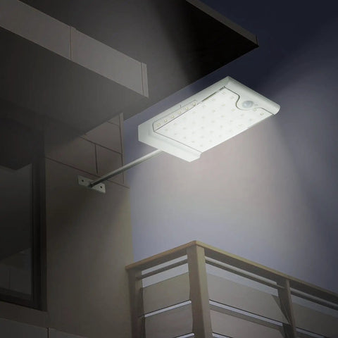 46 LED Solar Outdoor Lights With Mounting Pole 4 Modes Motion Sensor Wall Light illuminating a patio at night.
