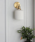 Wall Lamp, Nordic Minimalist Bedroom Light, Brass Ceramic Retro Lamps, wall-mounted fixture beside green plant.