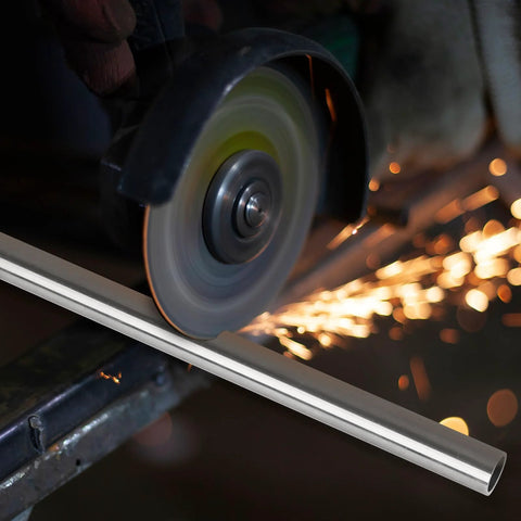 Side view of a 1/4 in OD stainless steel tube being cut by a grinding wheel with sparks.