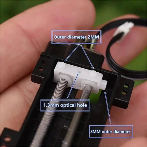 Close-up of a heavy duty linear actuator part showing details, dimensions, and optical hole, used in DIY automation projects.