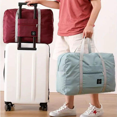 Person holding Foldable Travel Duffel Bag Set Two Pack Airline Friendly Carry On Luggage Weekender Tote For Women And Girls With Trolley Sleeve