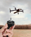 Hand holding High Torque Brushless Drone Motor 1300KV 45A Alloy Motor with 7 inch drone in background, outdoor setting