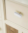 Sweet Finish T-Shaped Marble Cabinet Knobs With Brushed Brass Base, sharp drawer pull on light-colored dresser.