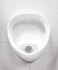 Non Para Green Apple Scent Urinal Screen With Blue Dye Indicator Water Soluble Design in a white urinal