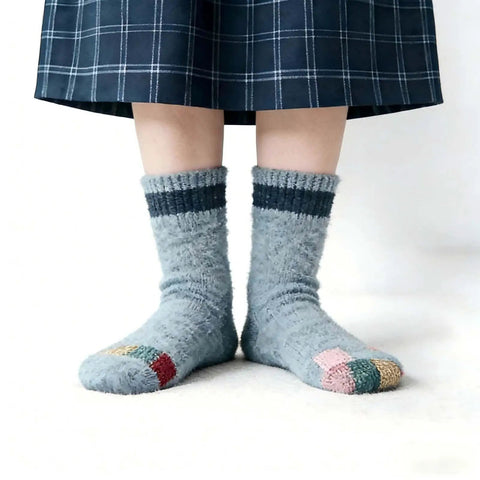 Person wearing repaired socks with patches from Complete Darning Kit With 14 Hook Mini Loom For Beginners Mushroom Patch Maker