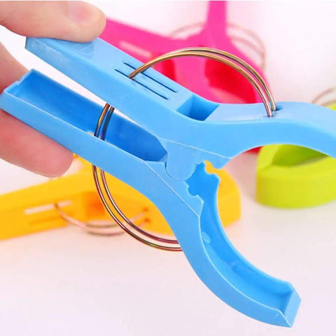 Close-up of blue clip from Heavy Duty Beach Towel Clips For Chairs And Loungers, Windproof Clips To Keep Towels, Swimsuits, And Gear From Blowing Away On Beach, Pool, Or Cruise Deck