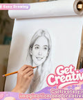 Hand drawing a portrait on an easel with motivational text 'Get Creative' for art inspiration.