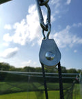 7/8 Inch Nylon Swivel Pulleys For Batting Cage Cable System shown in outdoor setup, clear sky background