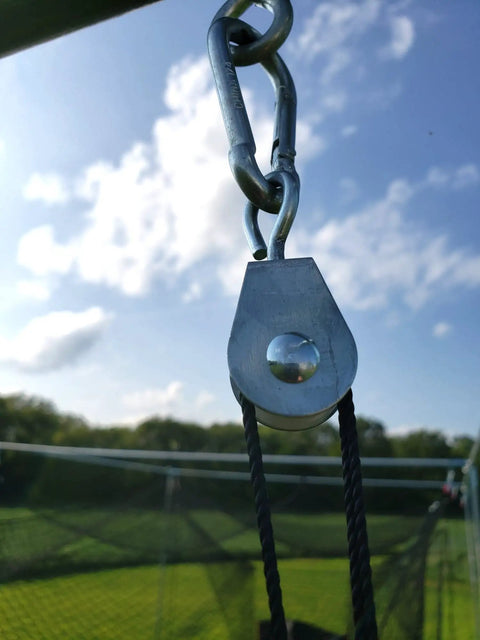 7/8 Inch Nylon Swivel Pulleys For Batting Cage Cable System shown in outdoor setup, clear sky background