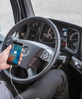 CarPlay charging cable in car; iPhone connected with white cable showing CarPlay on screen