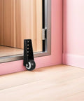 Bulletproof Anti Sag Gate Wheel For Wooden Barn Doors And Outdoor Fences Delivers Hella Smooth Silent Operation With Industrial Cold Rolled Steel Construction mounted on a pink wall.