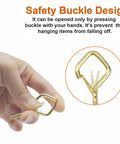 Close-up of gold Heavy Duty Eye Screw Hooks 35 Piece Set With Safety Buckle held in hand, illustrating buckle design details.