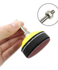Hand holding 2 Inch Drill Sander Attachment With Backer Plate And One Quarter Inch Shank 100 Piece Sanding Discs Pad Kit Includes 80 To 3000 Grit Sandpapers And Sponge Cushion For Fast Polishing And Smooth Finishes On Any Surface.