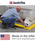 Man installing Make-A-Berm Fuel Spill Containment Curbs Kit, 15 Feet Long And 1.5 Inches High Straight Sections in a factory setup.