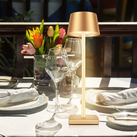 Cordless Table Lamp With Dimmable And Rechargeable Battery, Waterproof Gold Lampshade, placed on outdoor dining table with flowers