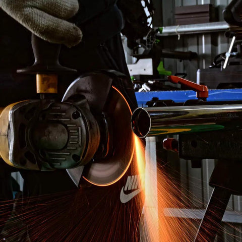 Heavy Duty 4.5 Inch Angle Grinder Cutting Discs Ripping Through Stainless Steel And Metal Jobs With Ridiculous Durability And Blazing Fast Cuts In 28 Pack Bundle in action cutting through metal with sparks.